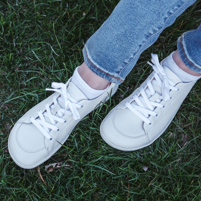 Mukishoes Cloud leather white soft barefoot sneakers worn against green grass