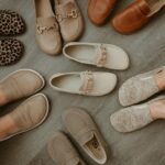 A collection of wide toe box barefoot loafers in neutral colors, prints, and stylish designs scattered around